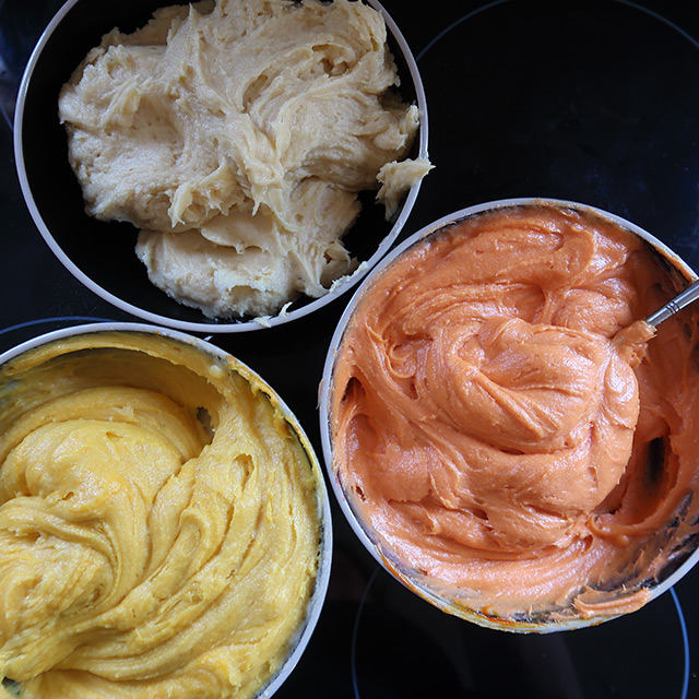 Cake mix in three colours for a Halloween Candy Corn cake